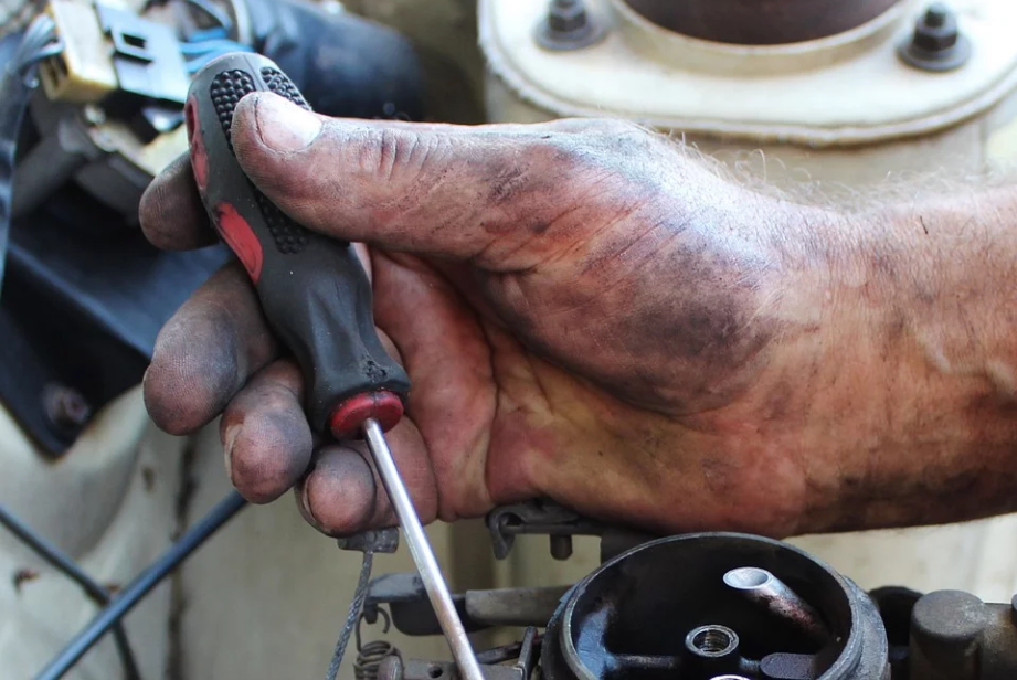 a mechanic holding a screwdriver